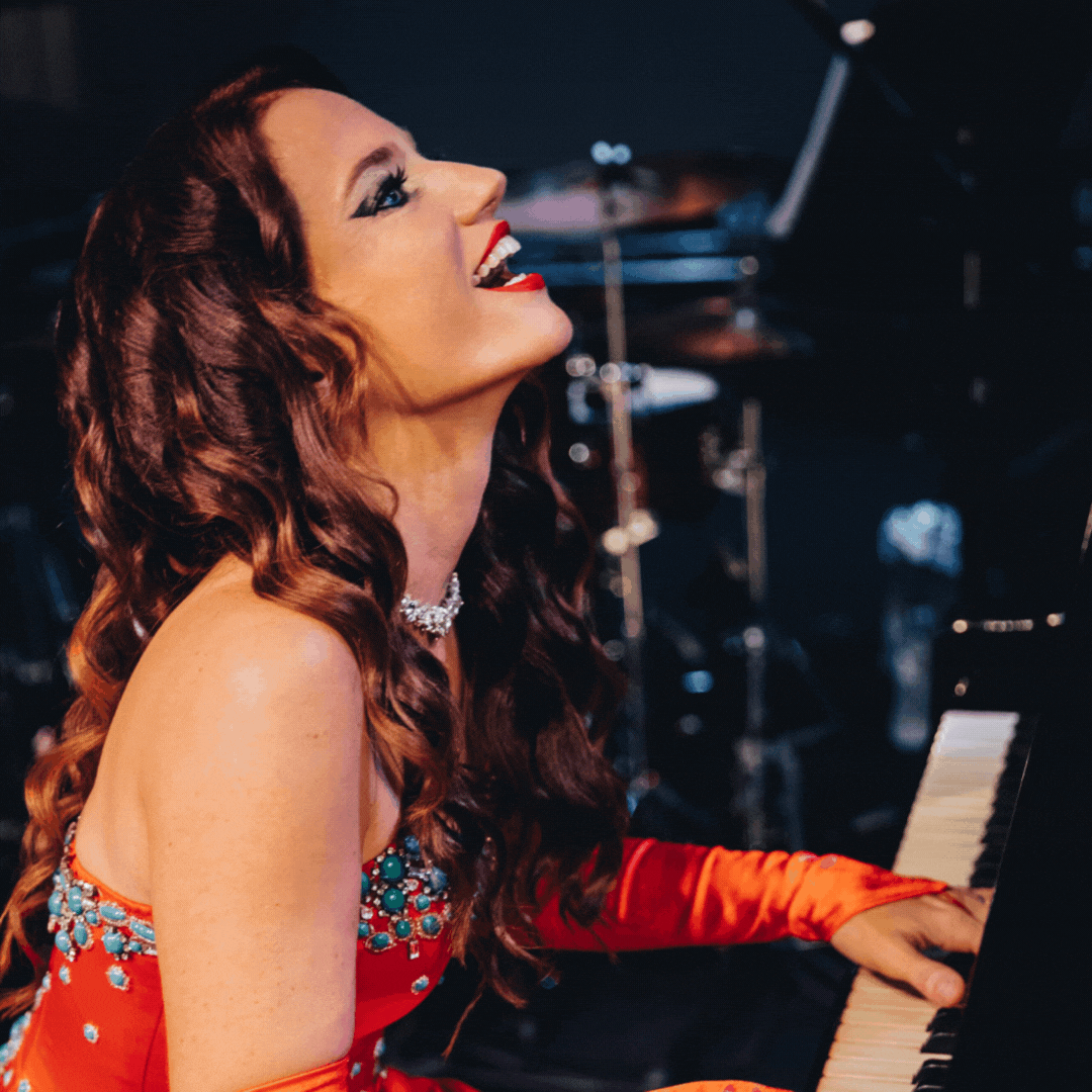 An image of Miami Pianist Mia Vassilev at the piano dressed in a beautiful gown.